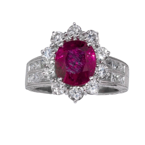 76 - ContinentalCirca 1980A fine ruby and diamond cluster ringThe central cushion shaped mixed cut ruby o... 