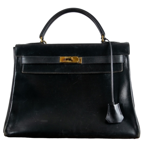 80 - HermèsCirca 1950A black Kelly handbagWith the original Hermès cotton drawstring dust bag and origina... 