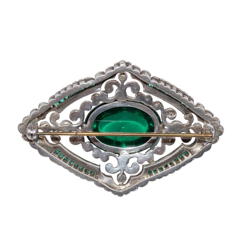 91 - EuropeanArt DecoA silver and paste brooch The central cabochon faux emerald within a surround of cal... 