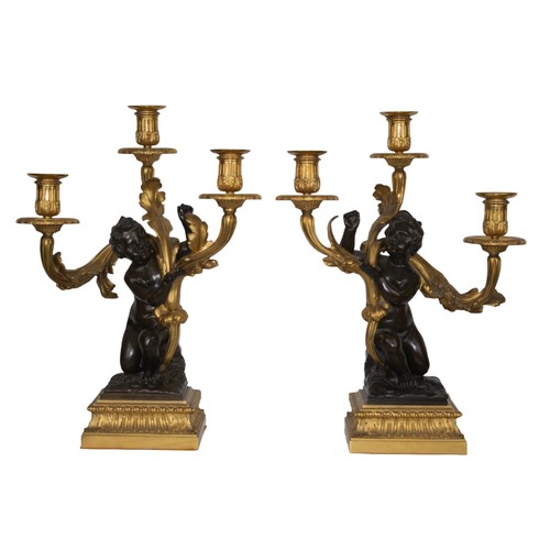 669A - FrenchLouis XVIA pair of Louis XVI bronze and ormolu putti three-branch candlesticksProvenance:Willi... 