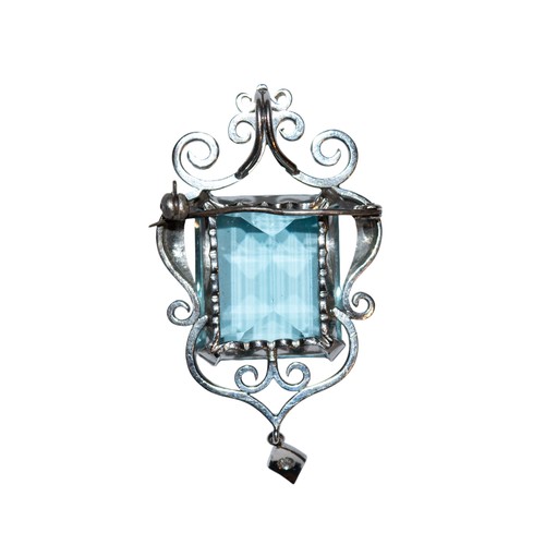 34 - ContinentalCirca 1960A large aquamarine and diamond pendant/broochThe step cut aquamarine of fine co... 