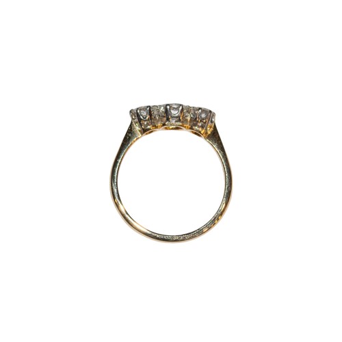 21 - BritishCirca 1936A diamond, yellow gold and platinum three stone ringThe central brilliant cut diamo... 