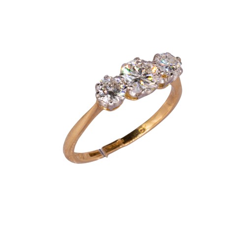 21 - BritishCirca 1936A diamond, yellow gold and platinum three stone ringThe central brilliant cut diamo... 