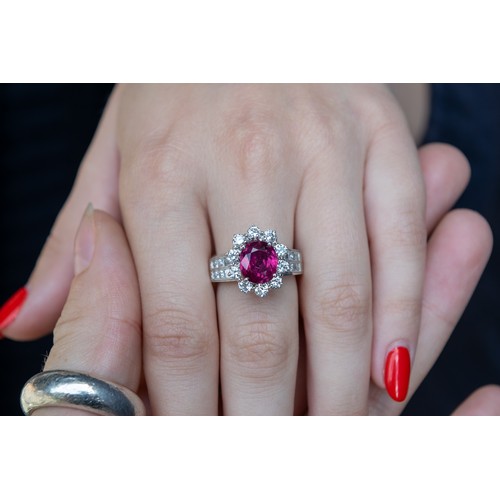 76 - ContinentalCirca 1980A fine ruby and diamond cluster ringThe central cushion shaped mixed cut ruby o... 