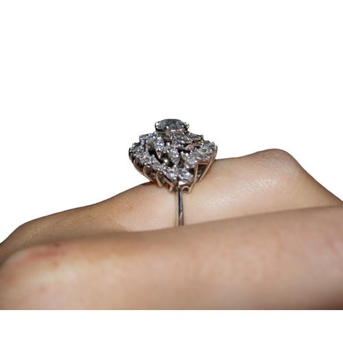 32 - BritishCirca 1990A diamond cluster ring, set to the centre with a single brilliant cut diamond. Appr... 