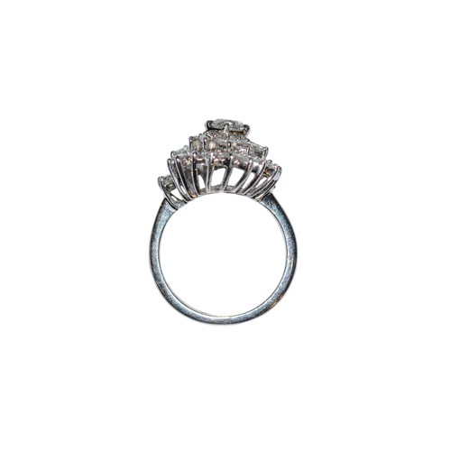 32 - BritishCirca 1990A diamond cluster ring, set to the centre with a single brilliant cut diamond. Appr... 