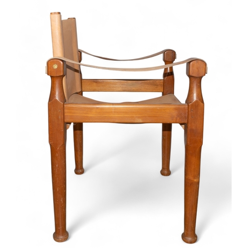 107 - Michael D'Souza MuftiAn Italian teak and tan leather safari chairDimensions:34 in. (H) x 24 in. (W) ... 