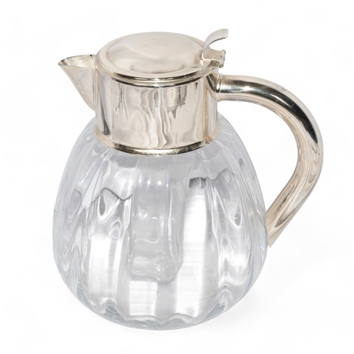 185 - A fine silver and glass jug, with ice inset Dimensions:10 in. (H)... 