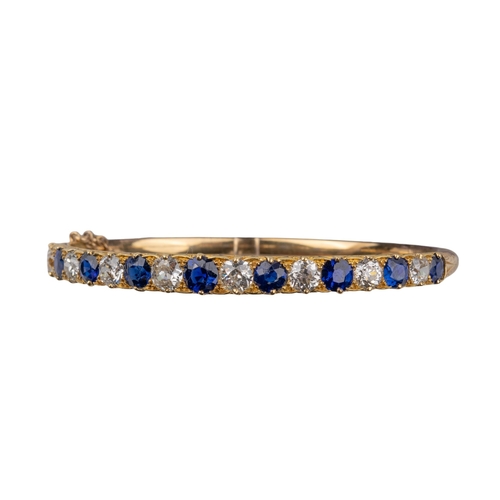 28 - BritishVictorianA fine sapphire and diamond half hoop bangleThe front set with nine slightly graduat... 