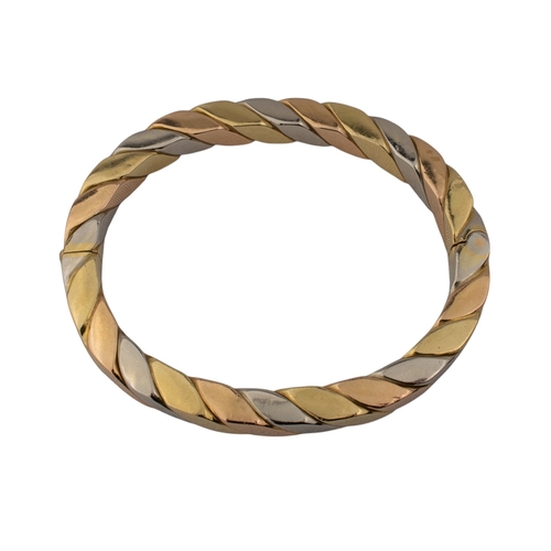 31 - ContinentalCirca 1980sA three coloured 18 carat gold flattened twist bangleWeight: Approx. 44.51 gra... 