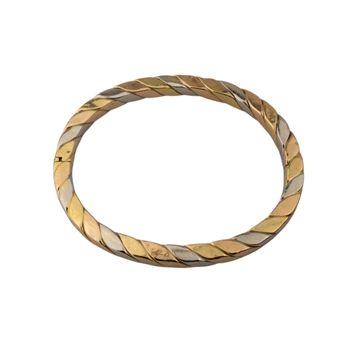 33 - ContinentalCirca 1980sA three coloured 18 carat gold flattened twist bangleWeight: Approx. 31.65 gra... 