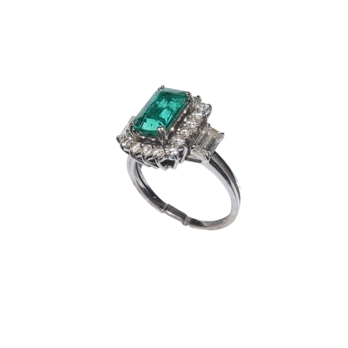 39 - ContinentalCirca 1960A fine Columbian emerald and diamond cluster ringThe rectangular emerald of sup... 