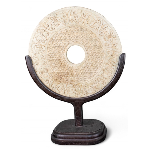 399 - ChineseA carved jade disk on a wood standDimensions:(Disk) 12 in. (D)(incl. stand) 17 in. (H) x 12 i... 