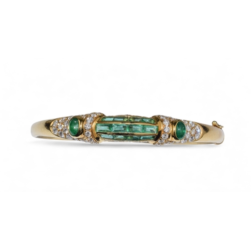 42 - ChaumetLondonCirca 1980An elegant 18 carat gold, calibré emerald and diamond bangleThe front arched ... 