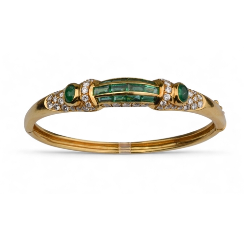 42 - ChaumetLondonCirca 1980An elegant 18 carat gold, calibré emerald and diamond bangleThe front arched ... 