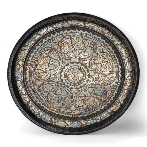 444 - Indianc.1850A small fine bidri ware charger, silver-inlaid. The dish of rounded form with slightly c... 