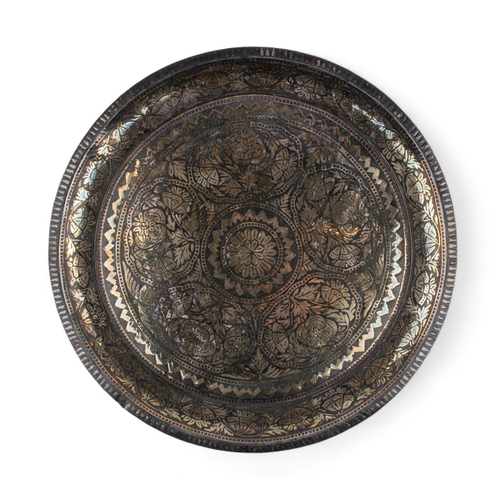 444 - Indianc.1850A small fine bidri ware charger, silver-inlaid. The dish of rounded form with slightly c... 