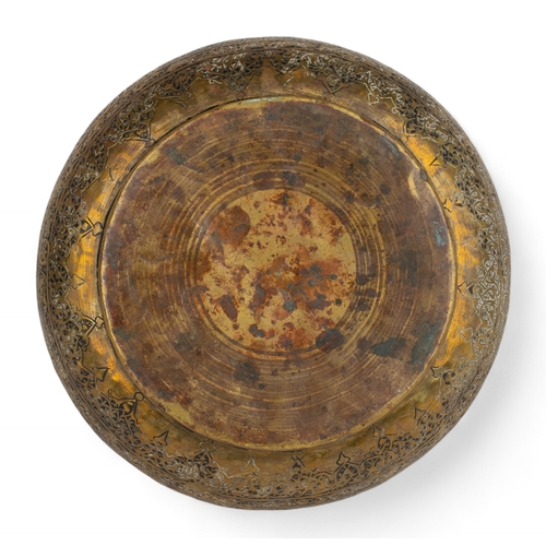 472 - Central Asia or Iran17th - 18th centuryA brass bowl, of compressed rounded shape on a flattened circ... 