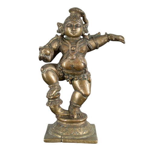 480 - Indianc. 1800BronzeA young dancing Krishna with a ball of butterThis small statue bears stylistic si... 