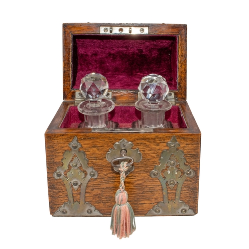 488 - BritishCirca 1890A pair of cut glass decanter scent bottlesWithin a Gothic style oak barrel top case... 