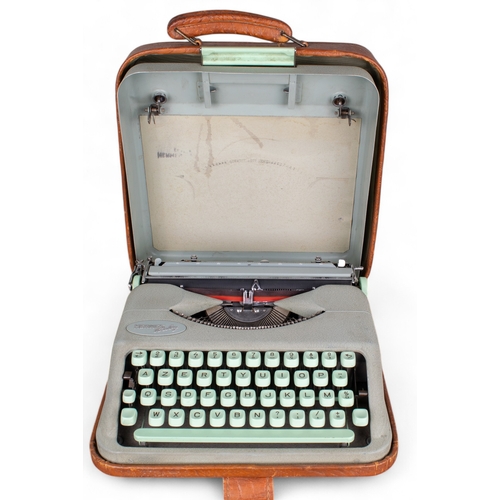 522 - HermèsCirca 1950A baby typewriterIn original brown leather caseWith two spools of new ribbon ... 