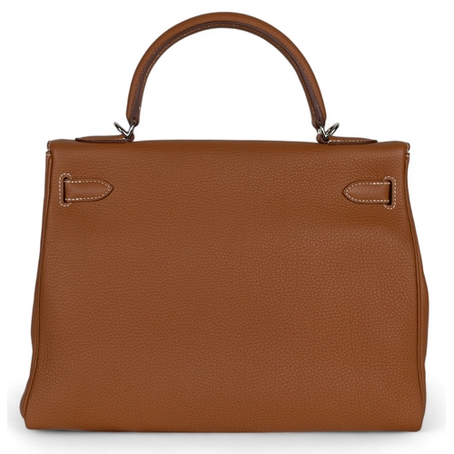 87 - Hermès2020A Kelly 32 retourne in gold togo leatherWith the clochette, keys, and padlock, and ... 