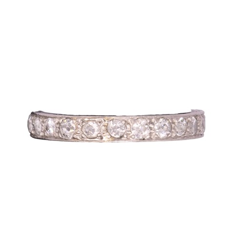 43 - BritishCirca 1920A diamond and platinum hoop ringComprising a row of old brilliant cut diamondsRing ... 