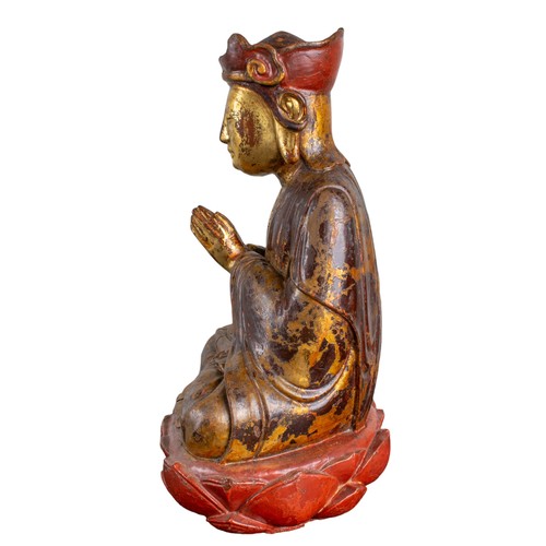 408 - Antique,A carved and lacquered Buddha at prayer with traces of polychrome and gilding, seated upon a... 