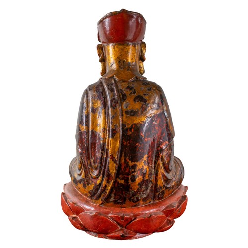 408 - Antique,A carved and lacquered Buddha at prayer with traces of polychrome and gilding, seated upon a... 