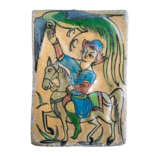 452 - Qajar (?)A moulded tile with hand-painted figure on horseback with bird flying overheadDimensions:8.... 