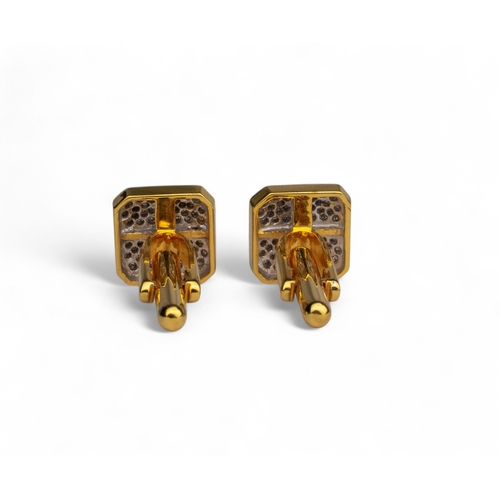 69 - Continental, ContemporaryA pair of yellow gold and diamond cufflinks designed as a wrapped presentWe... 