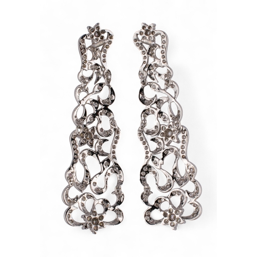 73 - Continental, Circa 1980sA pretty pair of diamond foliate scroll pendant earrings.Mounted in white go... 