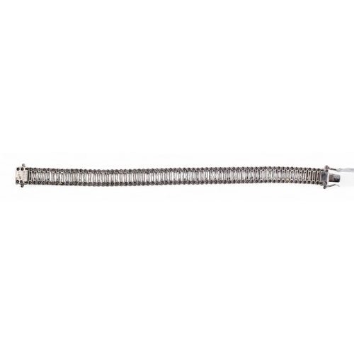 88 - Italian, ContemporaryA highly flexible three-row baguette and brilliant cut diamond line bracelet.Mo... 