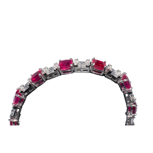 93 - Continental, ContemporaryAn attractive ruby and diamond line bracelet, composed of 12 cushion-shaped... 