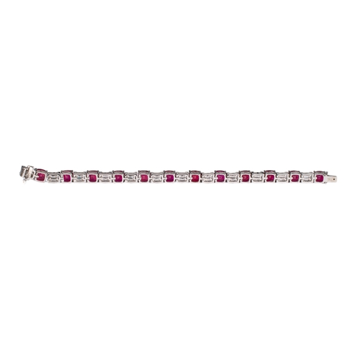 93 - Continental, ContemporaryAn attractive ruby and diamond line bracelet, composed of 12 cushion-shaped... 