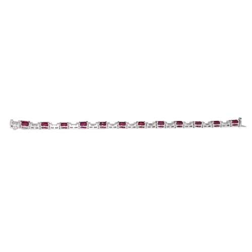 93 - Continental, ContemporaryAn attractive ruby and diamond line bracelet, composed of 12 cushion-shaped... 