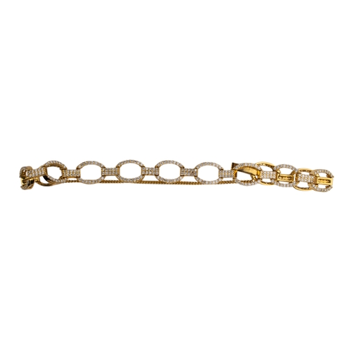 94 - Continental, ContemporaryAn 18 carat yellow gold and brilliant cut diamond oval link bracelet.Compos... 