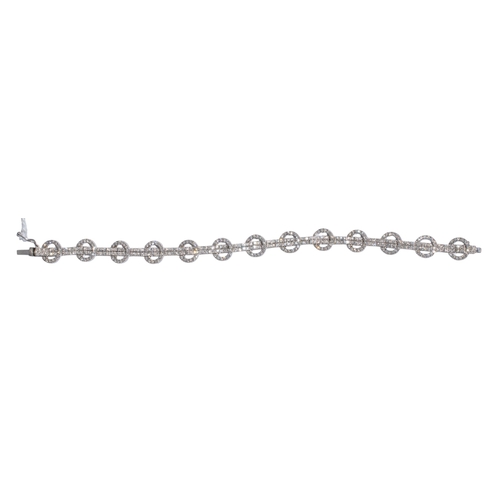 101 - Continental, ContemporaryAn attractive 18 carat white gold and diamond double-line and circles brace... 