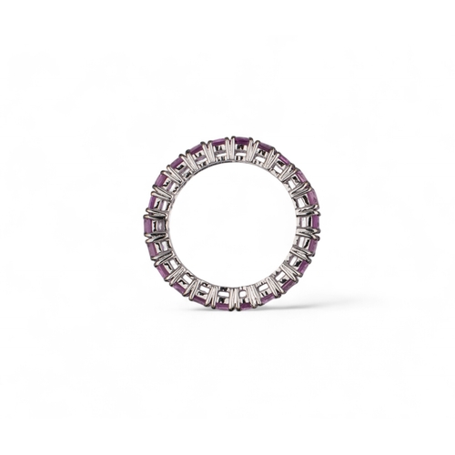 127 - Continental, ContemporaryAn 18 carat white gold and square-shaped pink sapphire band ring.The band s... 