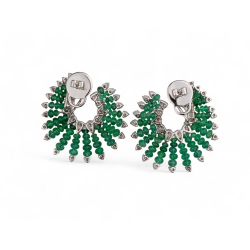 132 - Continental, ContemporaryA pair of emerald and diamond fan-shaped ear clips.Set through with emerald... 