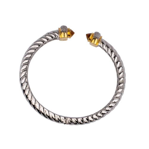 135 - Continental, ContemporaryA diamond and citrine cuff bangle.The silver-coloured metal twist bangle wi... 