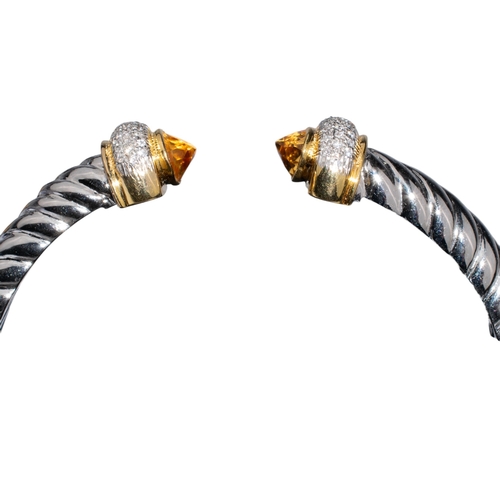 135 - Continental, ContemporaryA diamond and citrine cuff bangle.The silver-coloured metal twist bangle wi... 