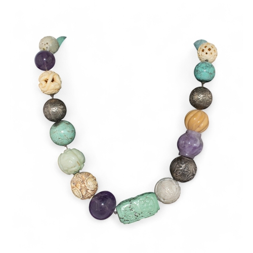 147 - Chinese and JapaneseCirca 1900A very unusual carved jade, amethyst, turquoise, silver and bone penda... 