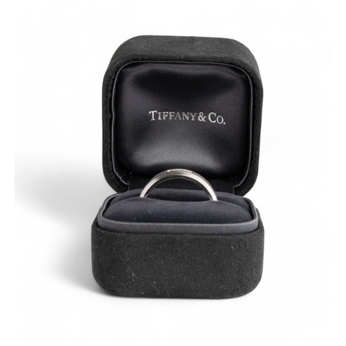 151 - Tiffany & Co., ItalyCirca 2004An 18 carat white gold band ring. The satin textured central band ... 