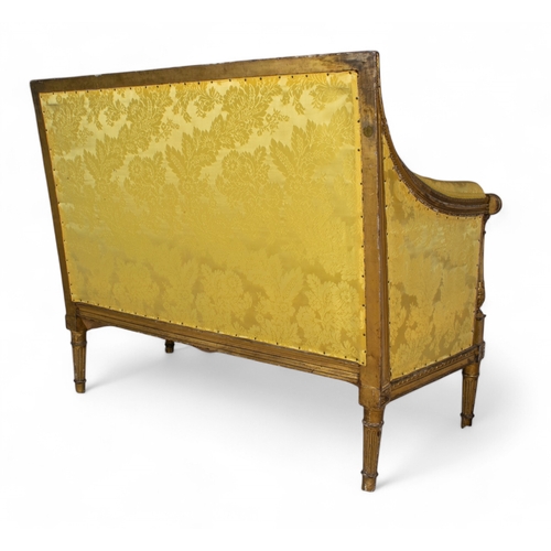 226 - Continental19th centuryA two seater setteeGiltwood, with yellow damask upholstery, on elegant fluted... 