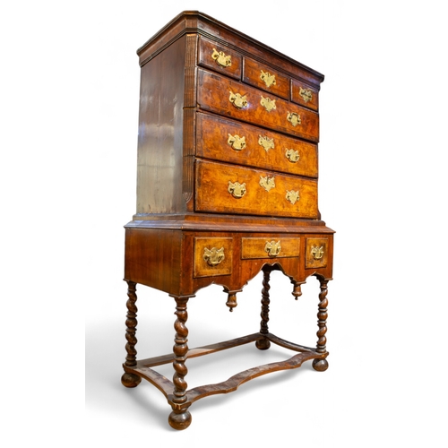 263 - BritishLate 17th, early 18th centuryA Queen Anne walnut chest on stand. The upper part comprising a ... 