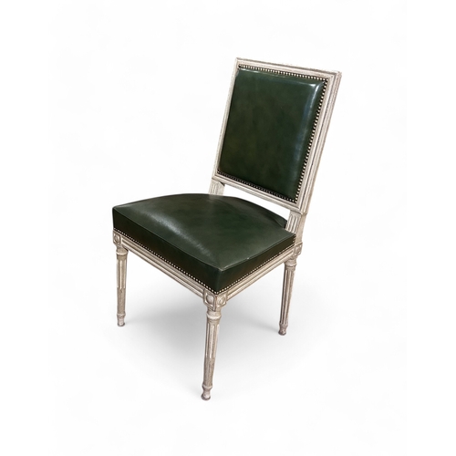 271 - FrenchA set of 14 lime painted and antiqued dining chairs, 12 in green leather, padded and backed. A... 