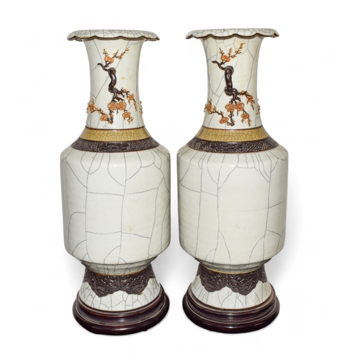 305 - Late 19th century, ChineseA pair of vases with prunus decoration to the topOn a wooden baseDimension... 