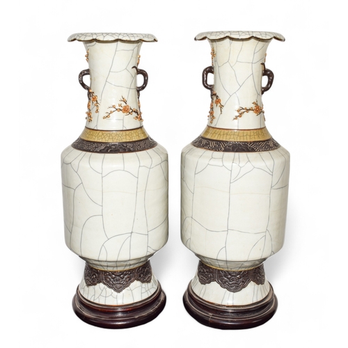 305 - Late 19th century, ChineseA pair of vases with prunus decoration to the topOn a wooden baseDimension... 