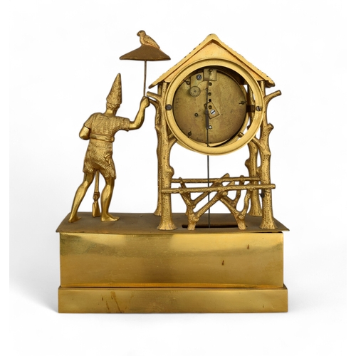 328 - A French Empire style gilt mantel clock in Oriental taste, with the figure of a man holding a rifle ... 